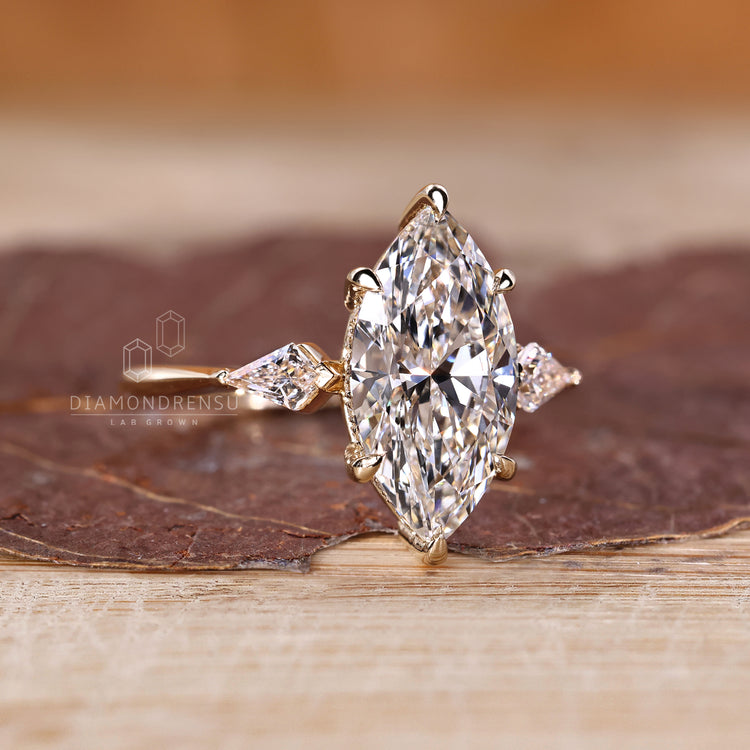 Lab grown three stone ring with tapered shank band.