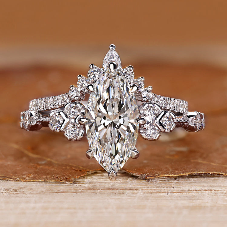 Marquise wedding ring set with round side stone and muse setting.