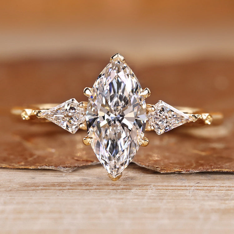 Marquise cut diamond ring with kite side stone.