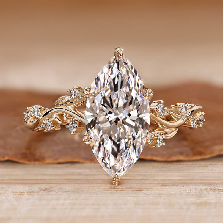 Marquise cut engagement ring with round side stones.