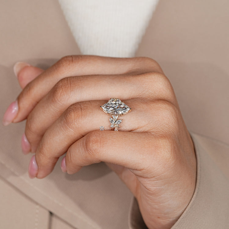 Nature inspired diamond ring with marquise and round stones.