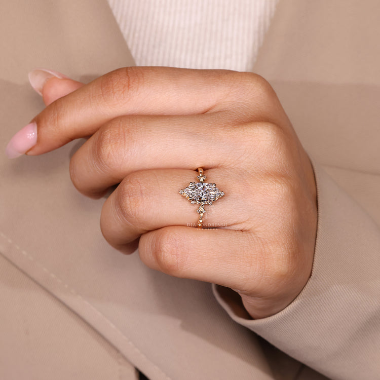 Nature inspired marquise ring with round accent diamonds design.