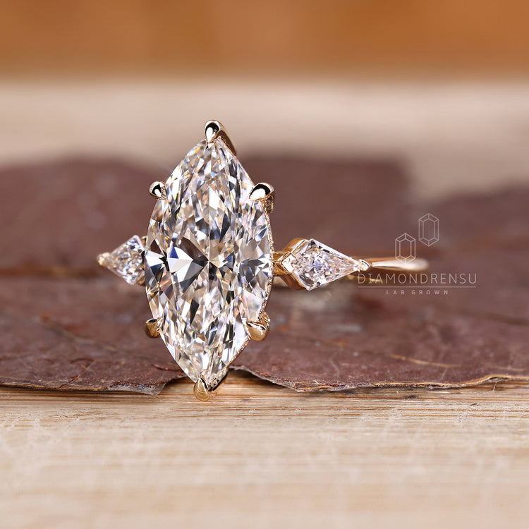 Three stone ring with marquise centre and kite side stones.