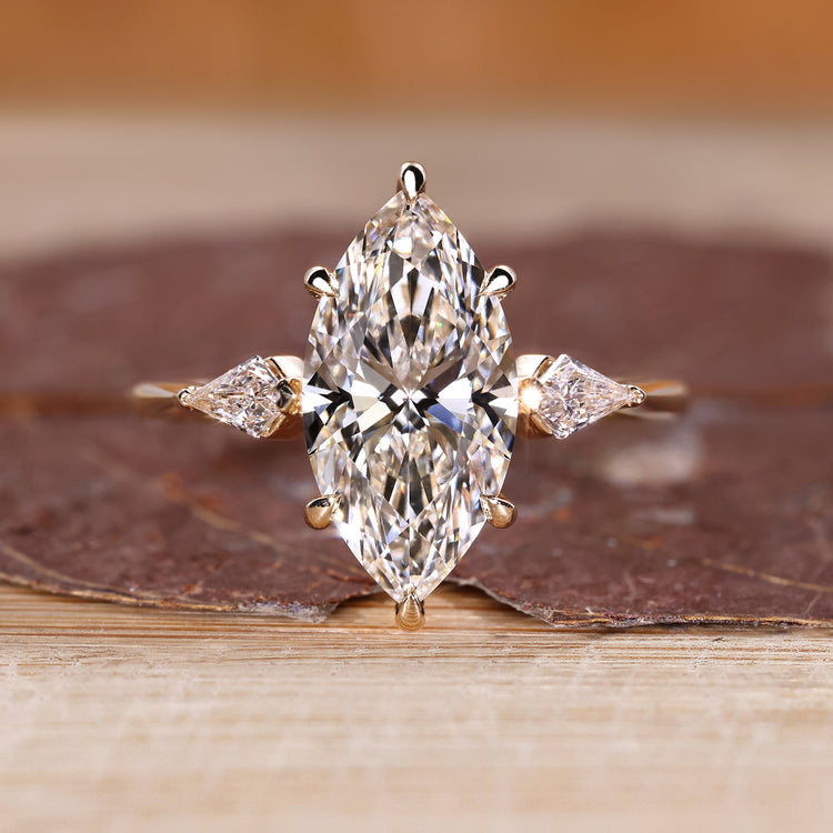 Three stone engagement ring with marquise cut centre diamond.