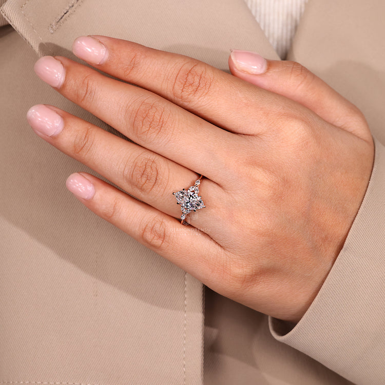 Handmade marquise ring with side stones and claw prong.