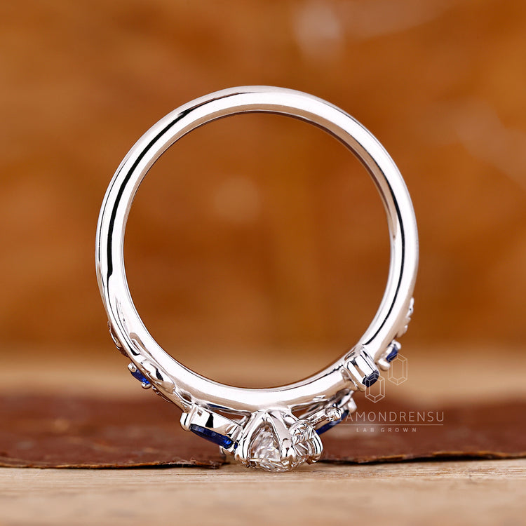 Lab grown marquise diamond ring with intricate leaf setting.