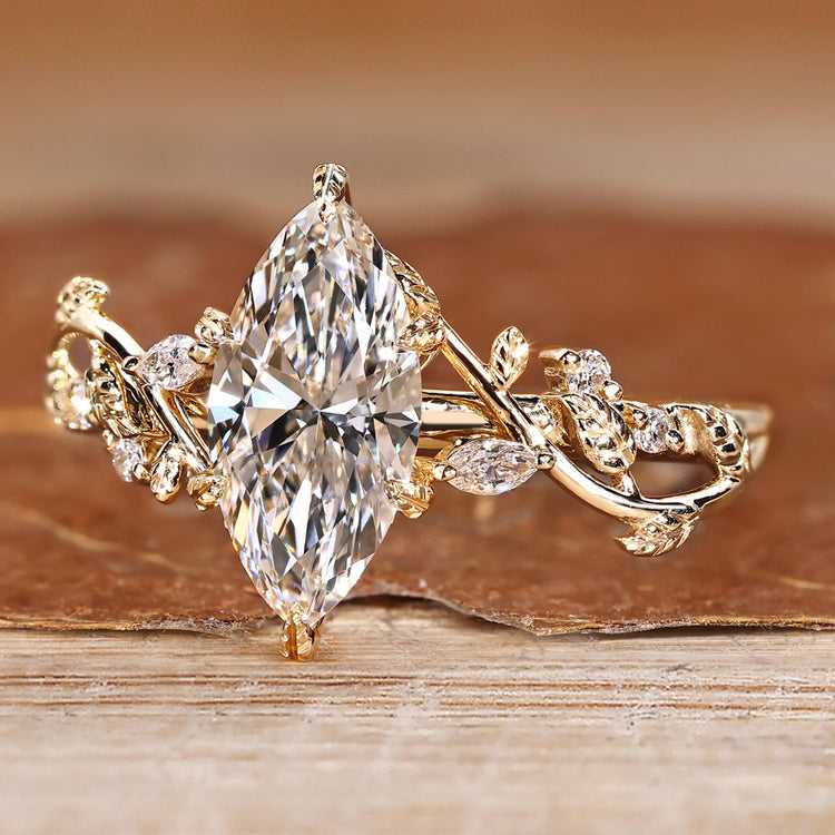 Marquise cut engagement ring with round side stones.