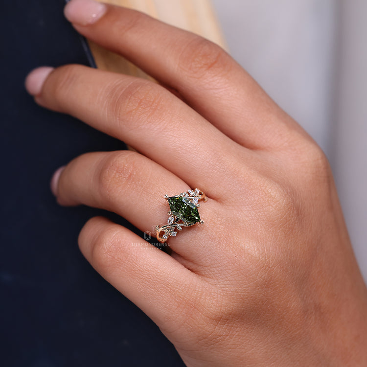 Green diamond ring with marquise and round side stones.