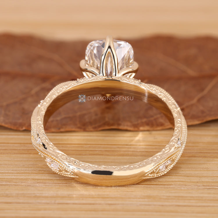 Cushion cut diamond ring with tulip setting.