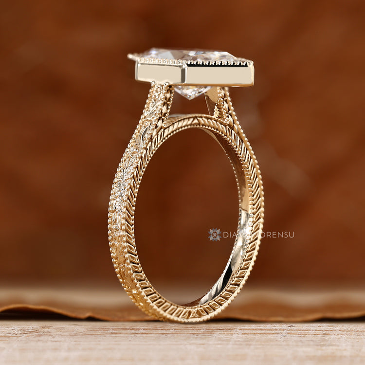 Bezel set solitaire diamond ring with cathedral setting.