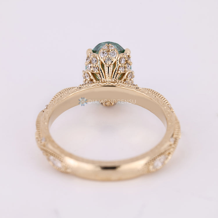Oval cut ring with art deco style and filigree.