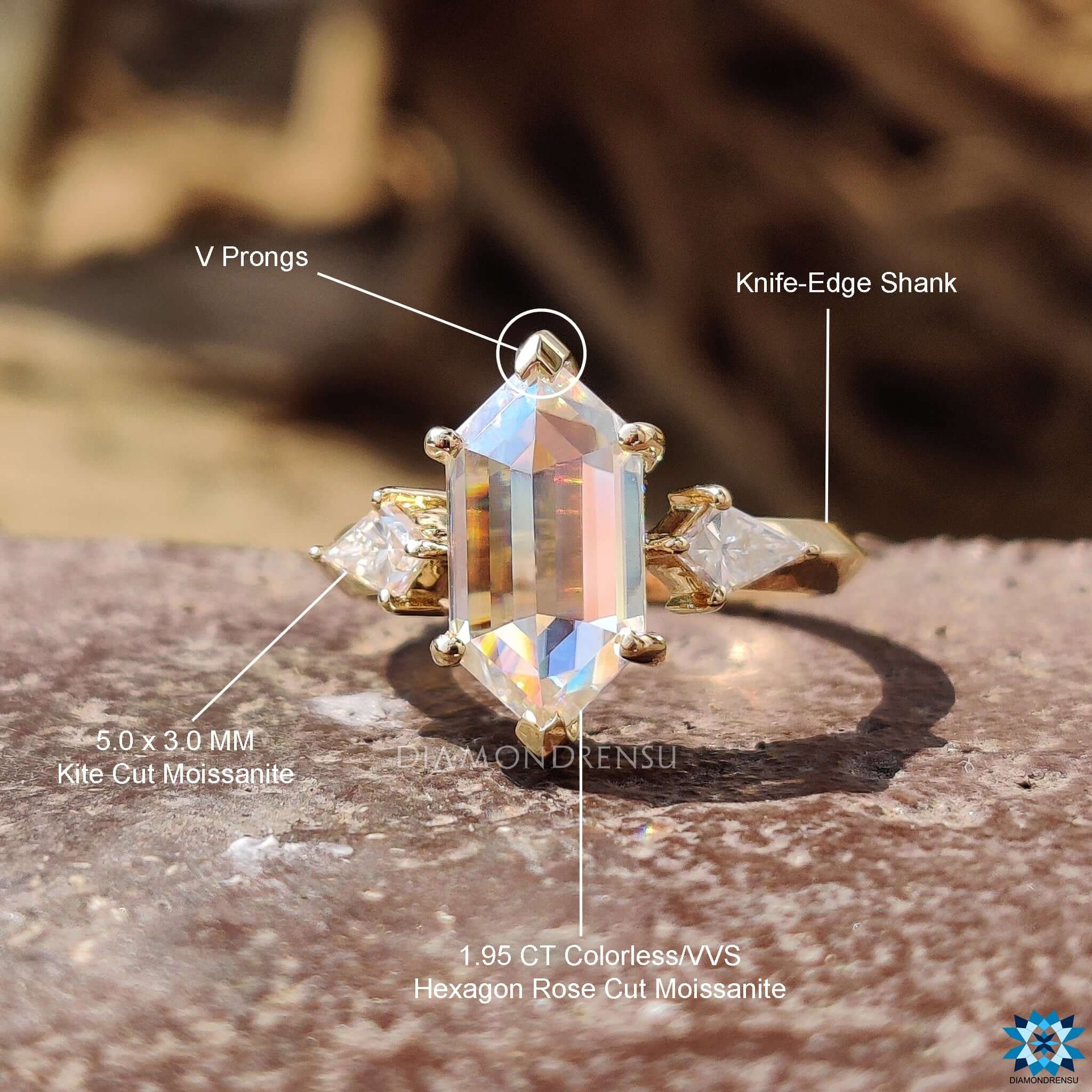 Unique three stone ring with kite side accents.