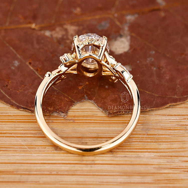 Nature inspired oval ring with marquise side stones.