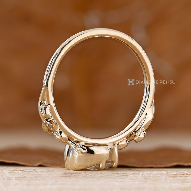 Nature inspired diamond ring with round side stones.
