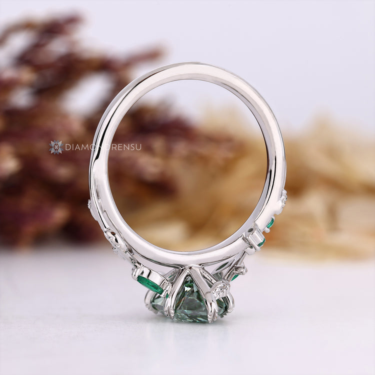Green Dutch marquise cut diamond with round side stones.