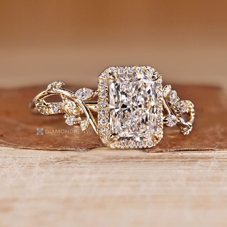 Radiant cut diamond ring with round halo setting.