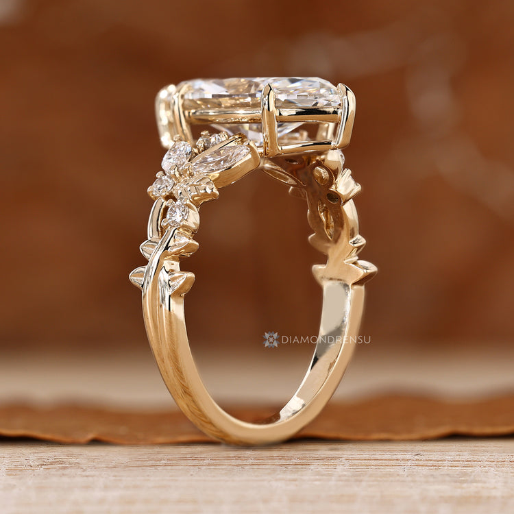 Marquise engagement ring with round side stone accents.