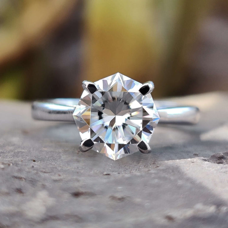 Octagon cut moissanite solitaire ring in white gold.