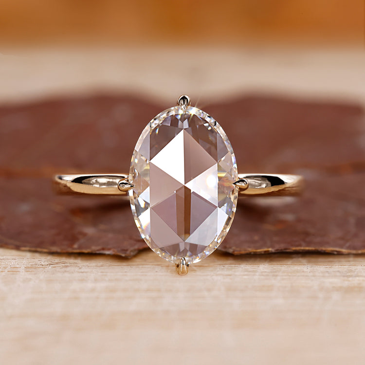 Solitaire engagement ring with oval rose cut diamond.