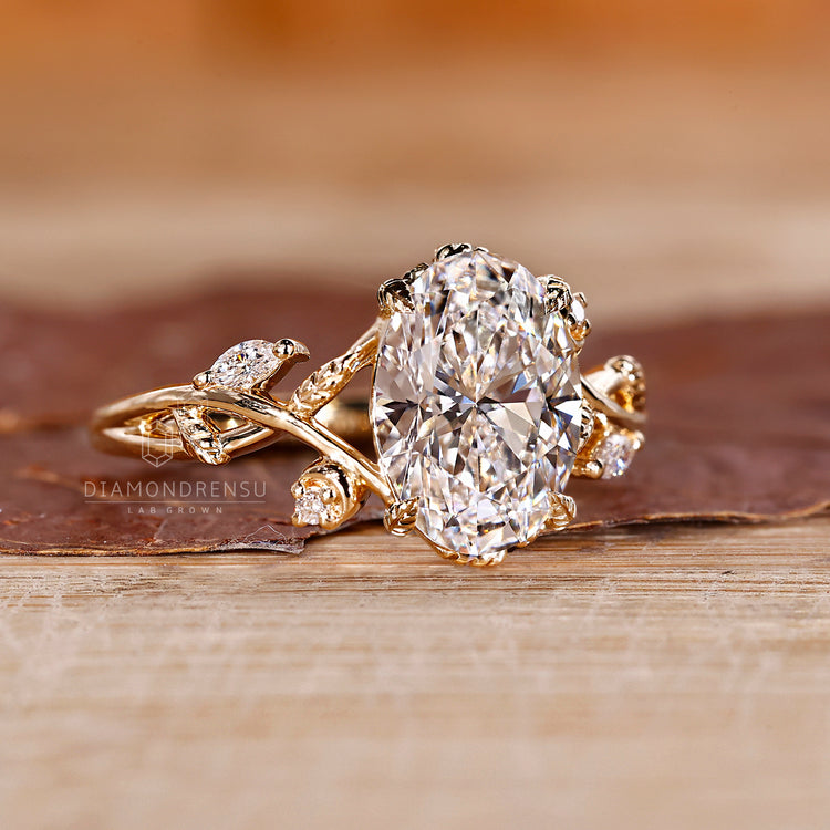 Lab grown oval diamond ring with leaf vine design.