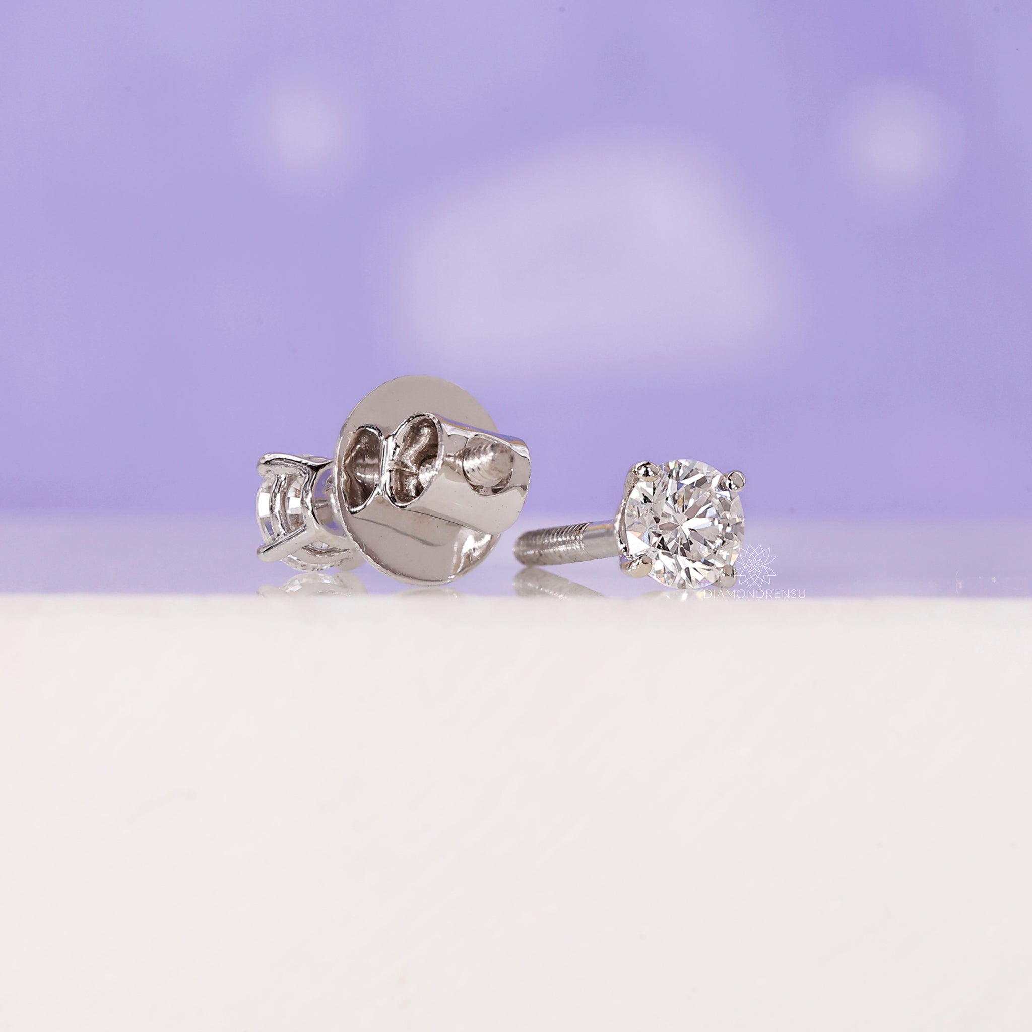 Small round cut diamond studs.
