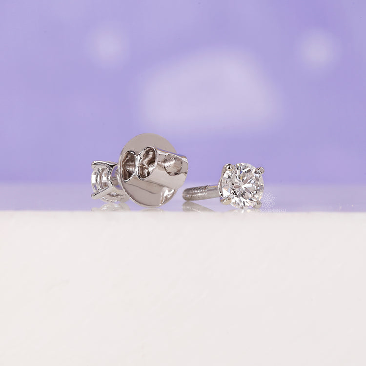 Small round cut diamond studs.