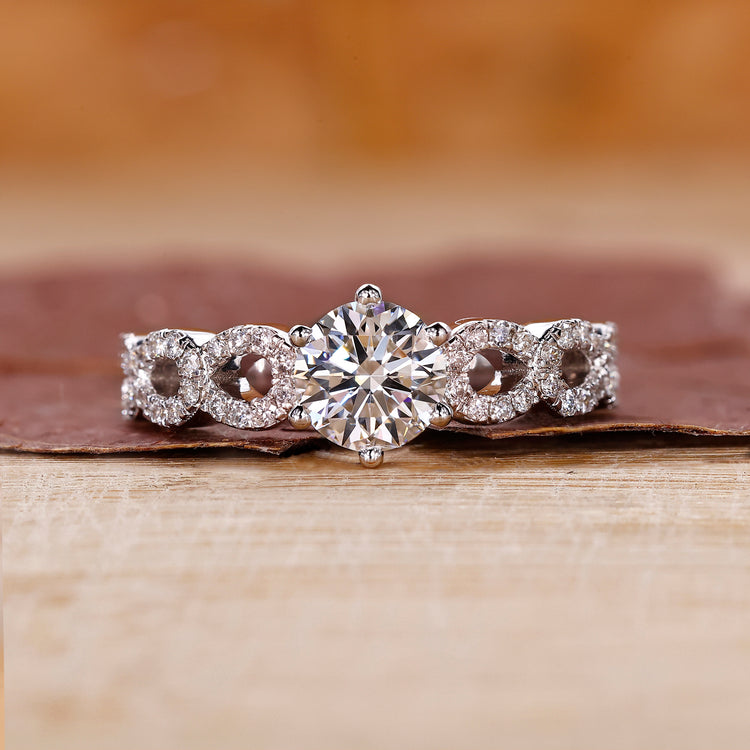 White gold engagement ring featuring a round diamond in a 6 prong setting.