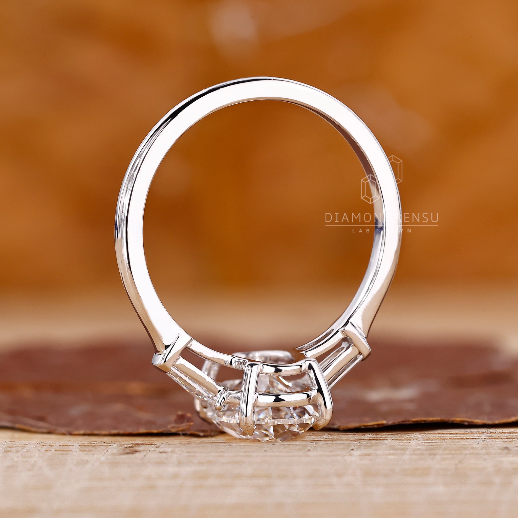 Four prong engagement ring with tapered baguette accents