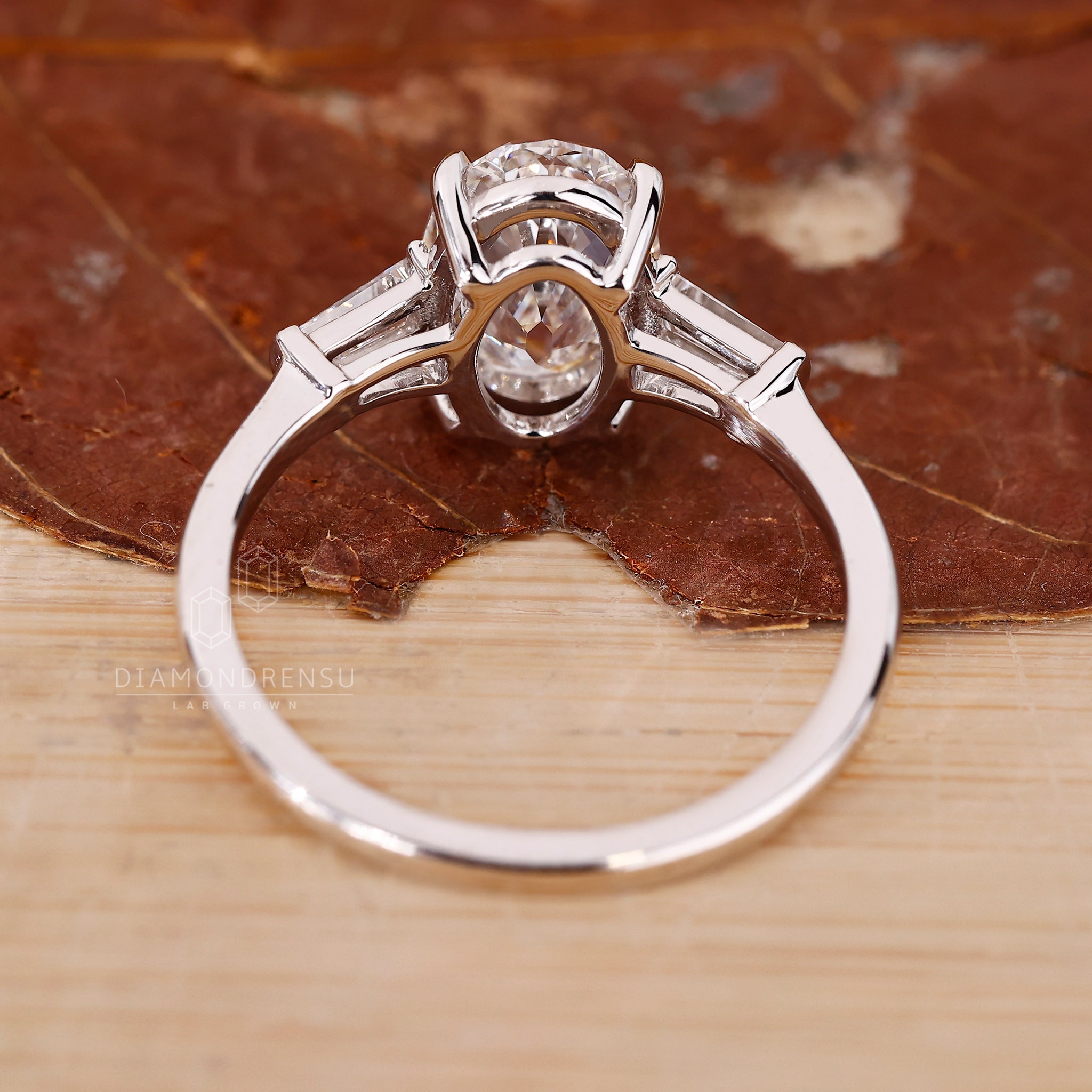 UK engagement ring with oval old cut diamond and baguettes