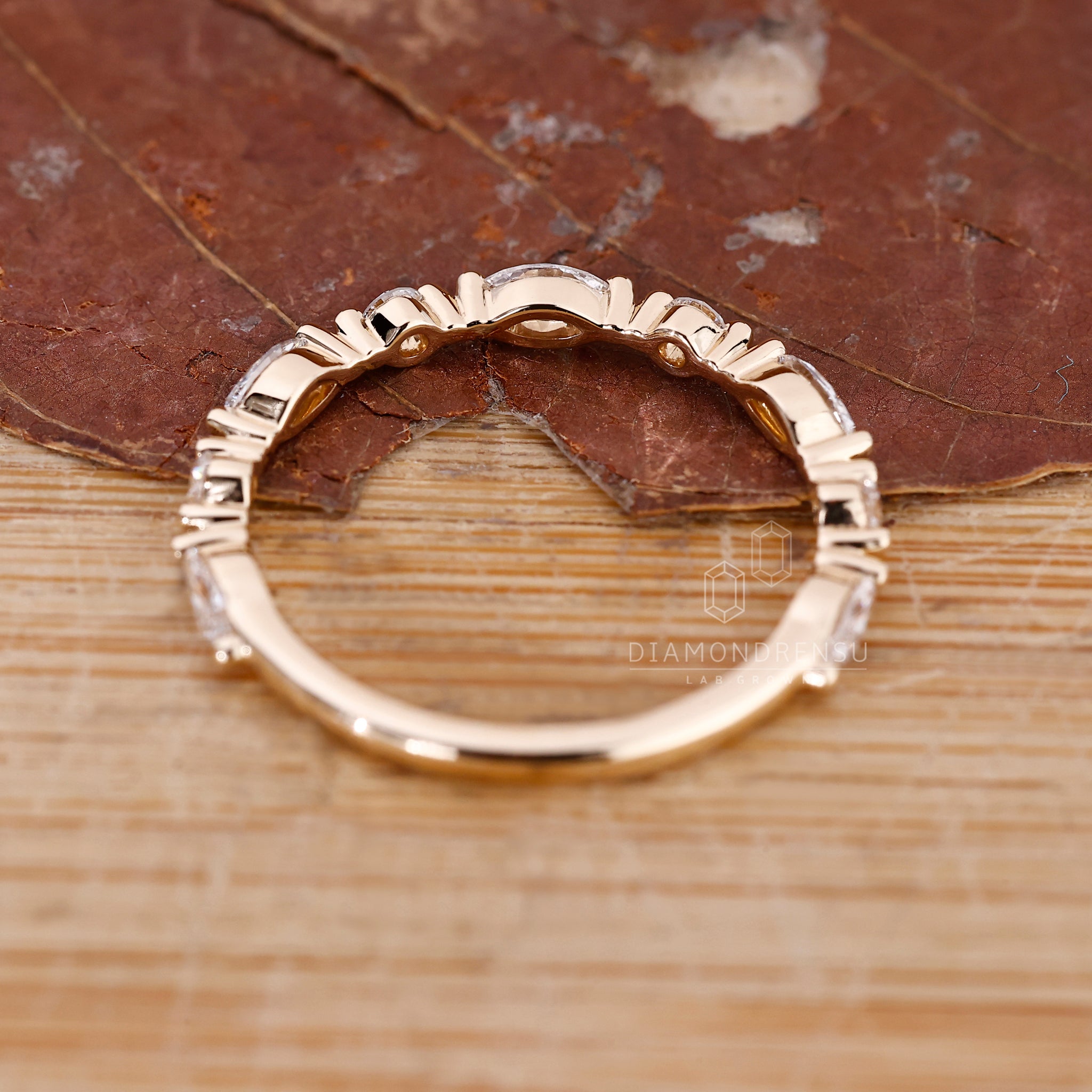 Shared prong wedding band with lab grown marquise and round diamonds.