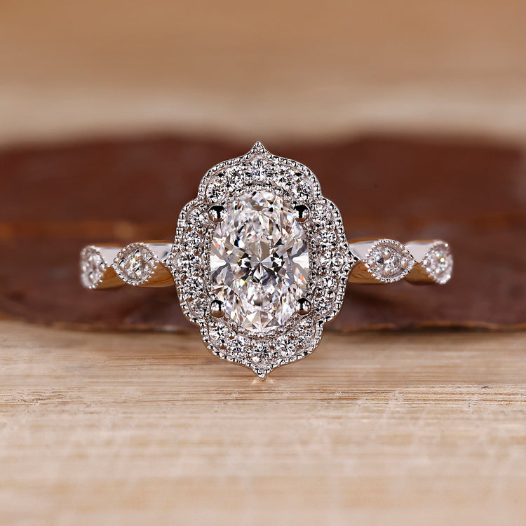 Oval halo ring with marquise shape outline.