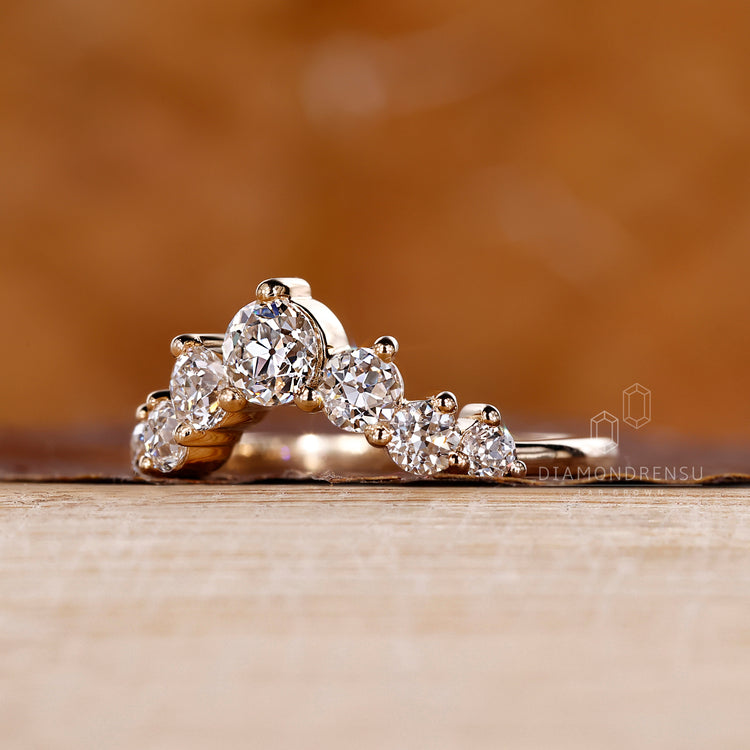 Shared prong wedding band with a curved fit.