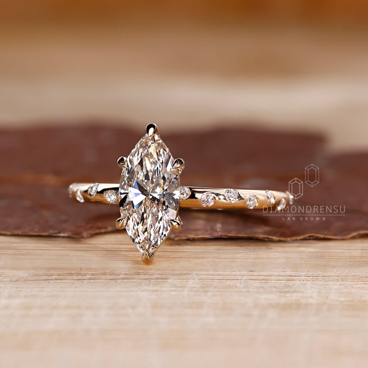 Flush pave band paired with a marquise center.
