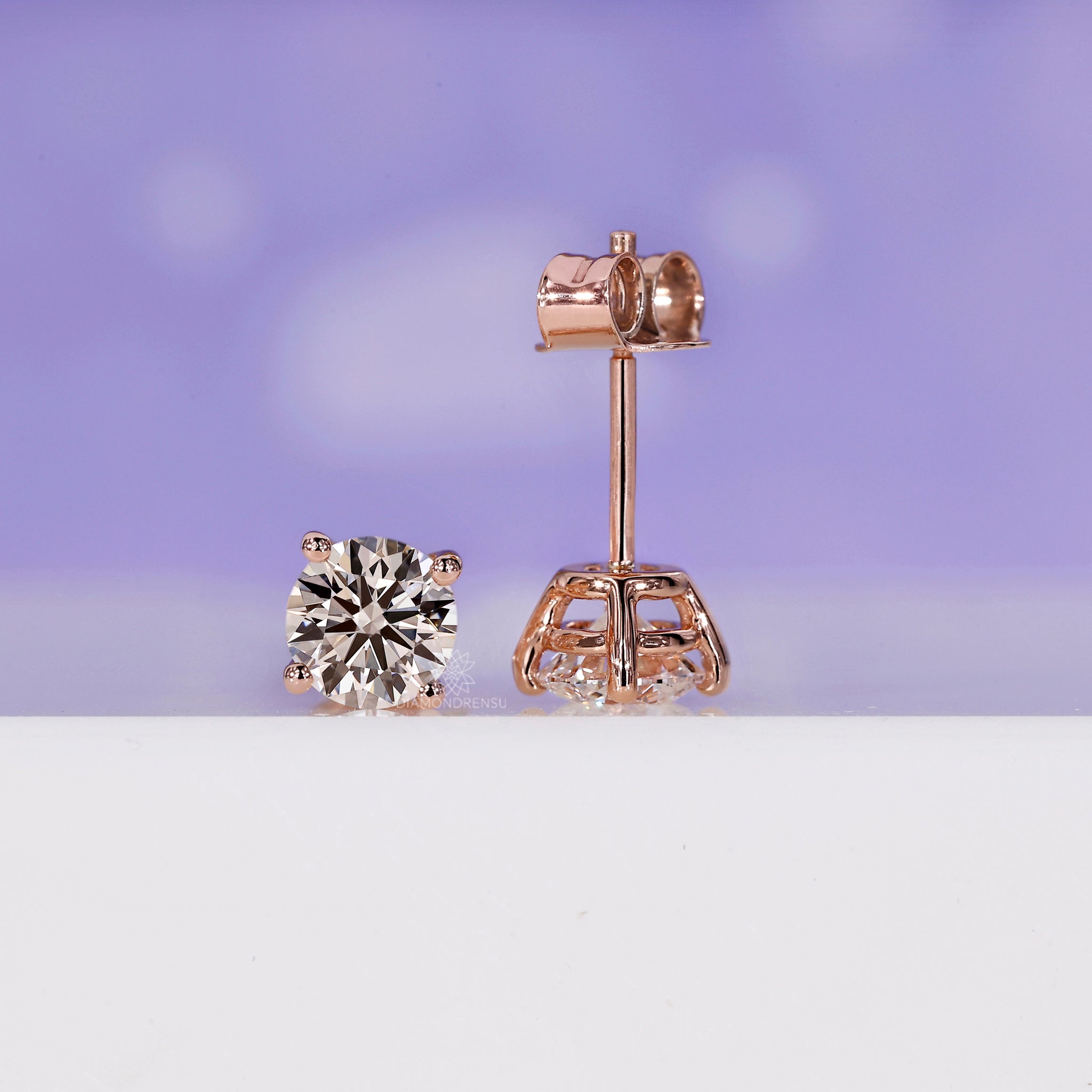 Handmade rose gold diamond stud earrings with secure prong settings.