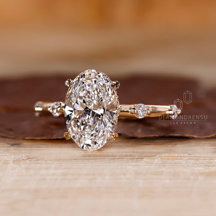 Hidden halo setting with round cut diamond accents.