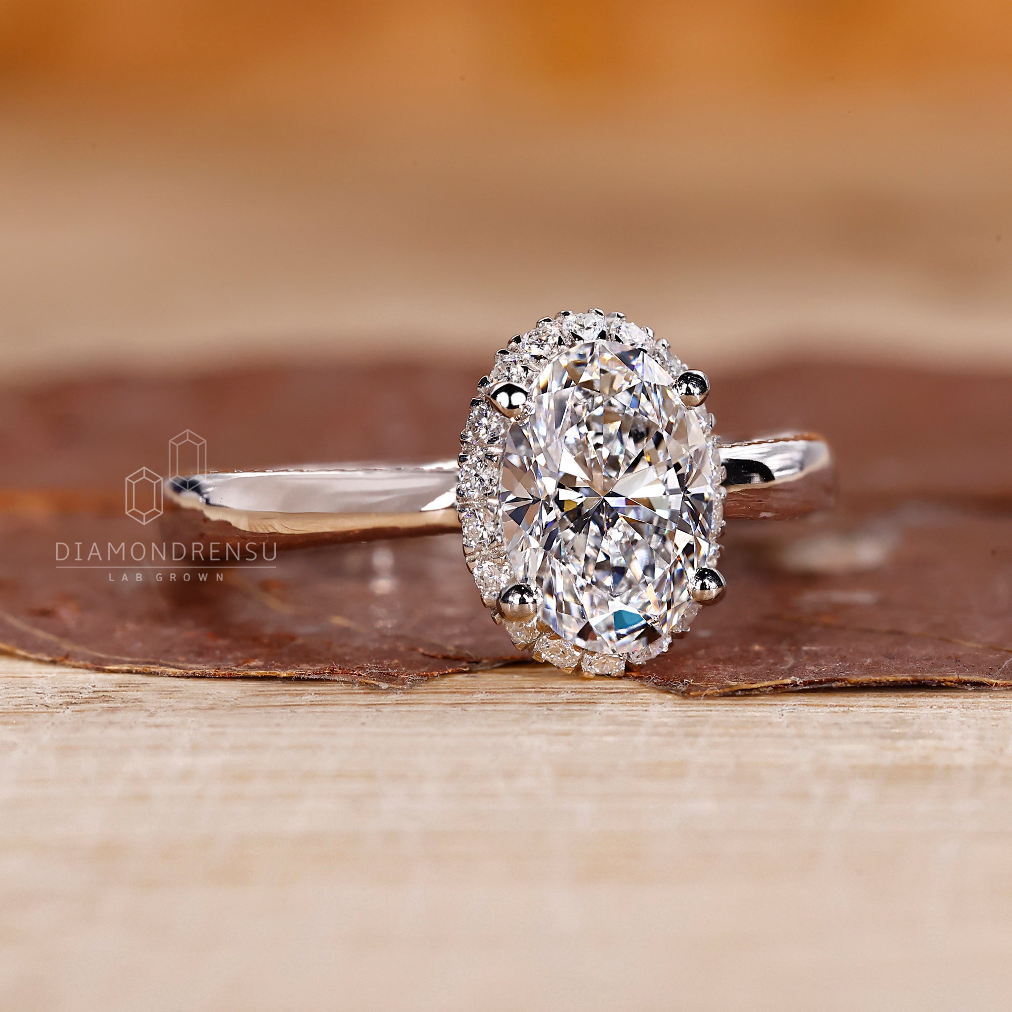 White gold ring with oval center and pave accents