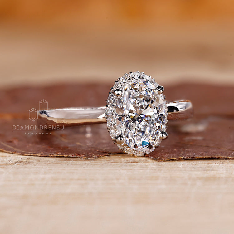 White gold ring with oval center and pave accents