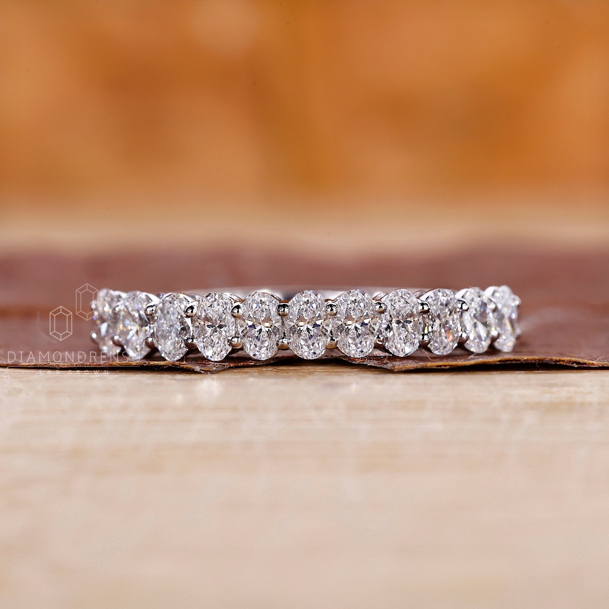 Prong set wedding band designed with lab grown oval diamonds.