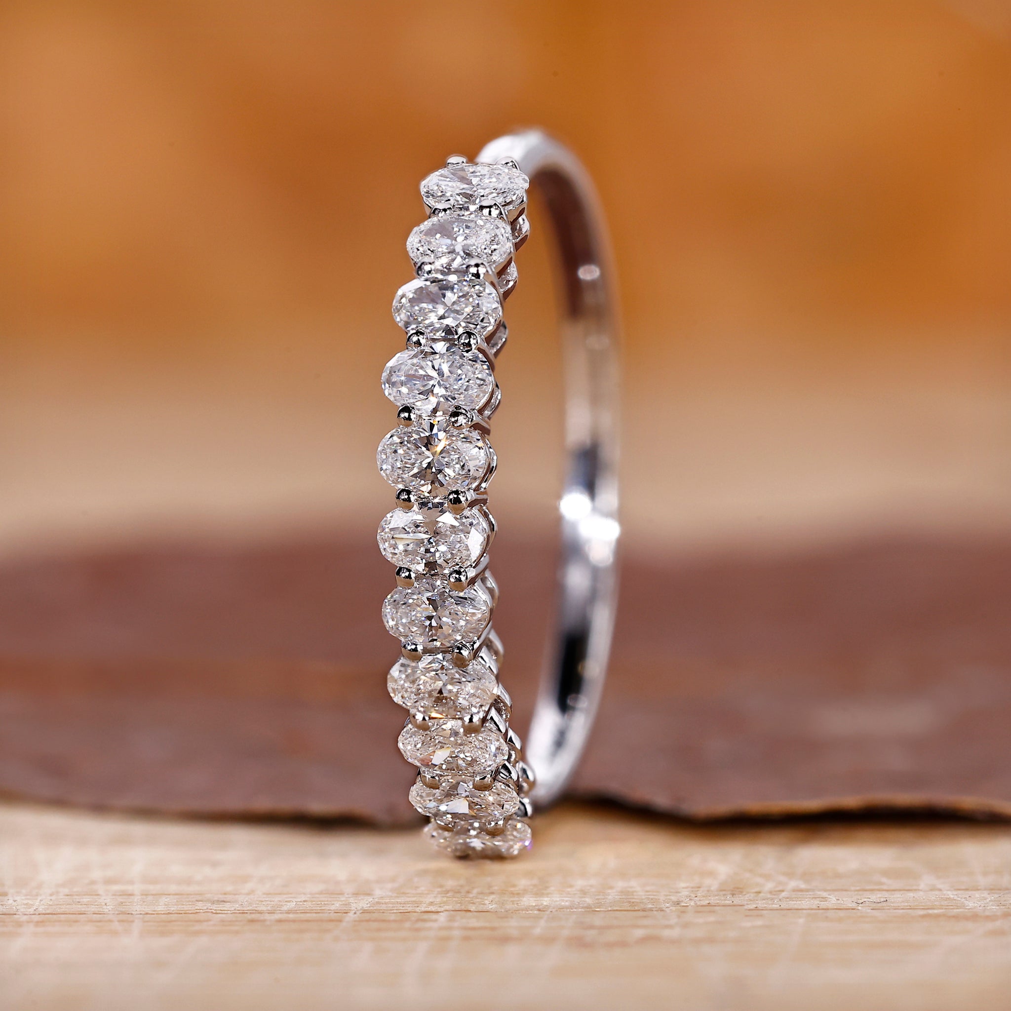 Oval diamond wedding band crafted in white gold with a sleek finish.