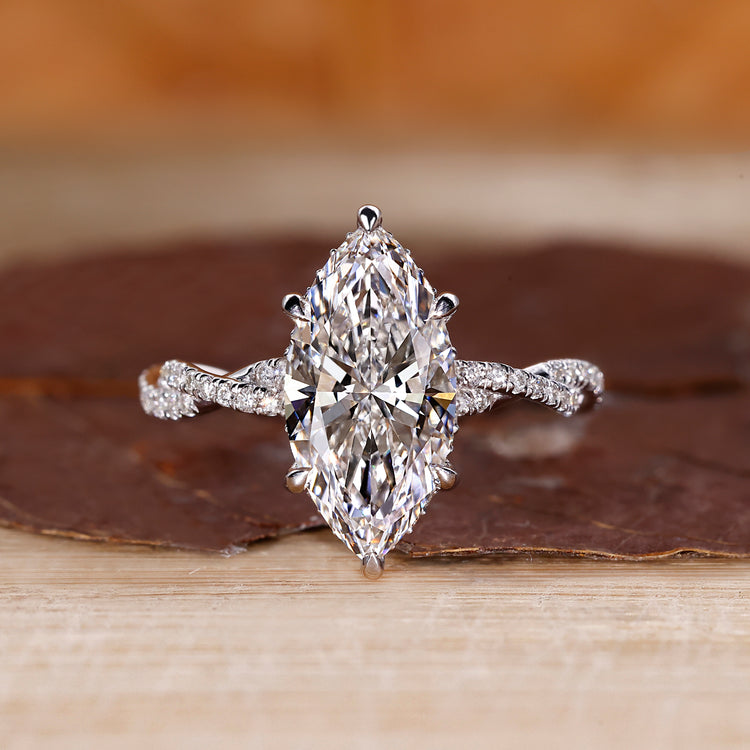Twisted pave engagement ring with marquise cut diamond.