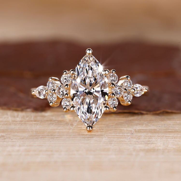 Marquise cut ring with round and pear side stones.