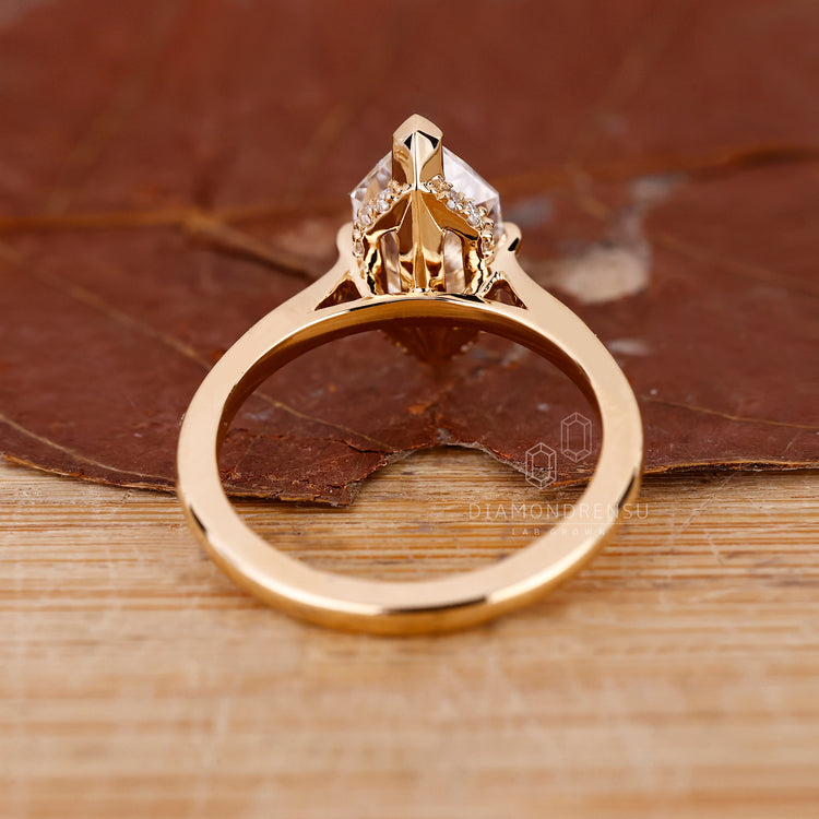 Round cut hidden halo setting placed in custom engagement ring.