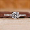 Round cut engagement ring with pave setting.