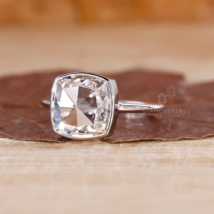 White gold solitaire ring with cushion diamond