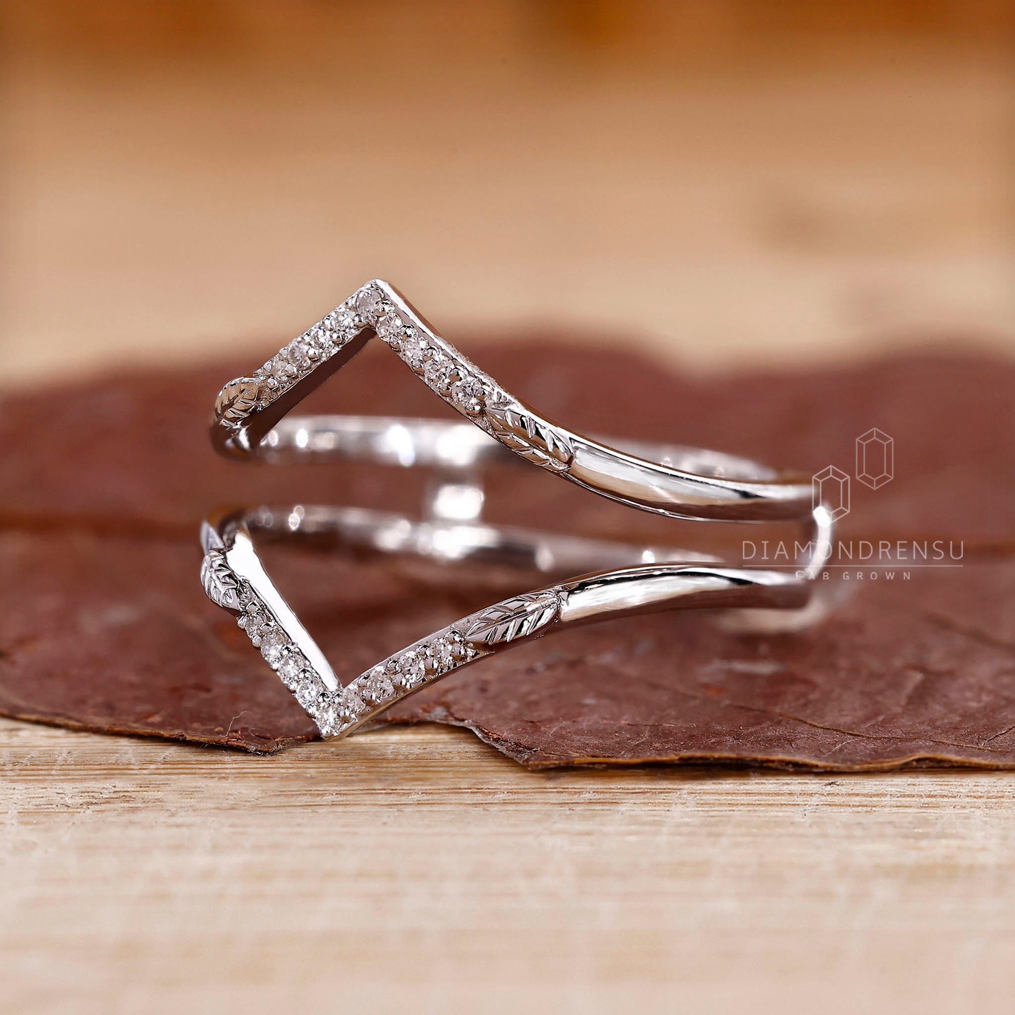 White gold wedding band in a curved V shape.