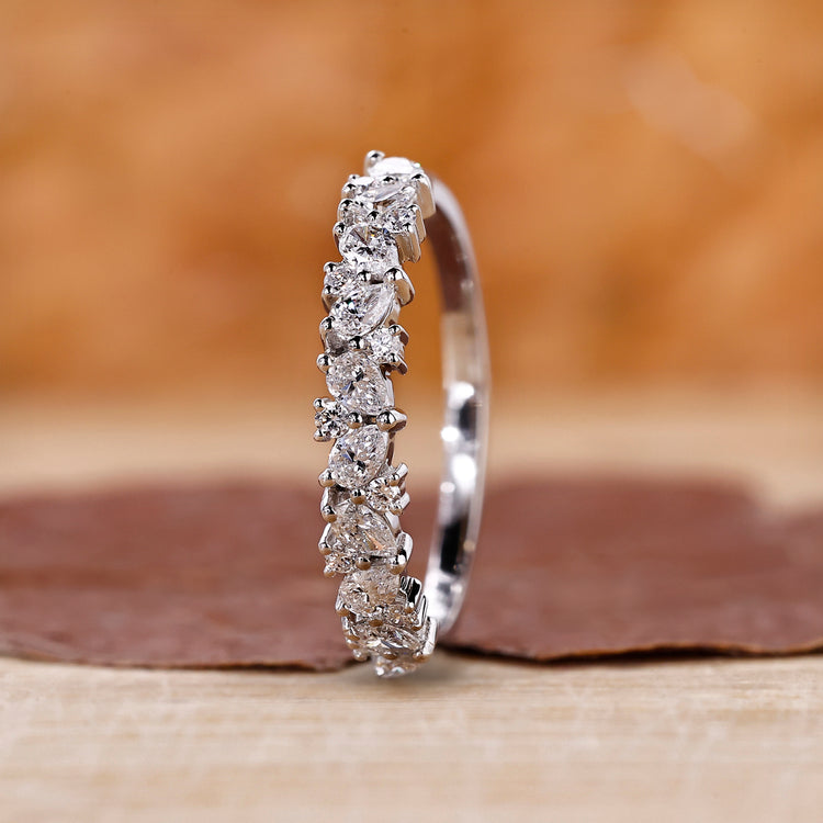 Teardrop wedding band with pear and round cut diamonds.
