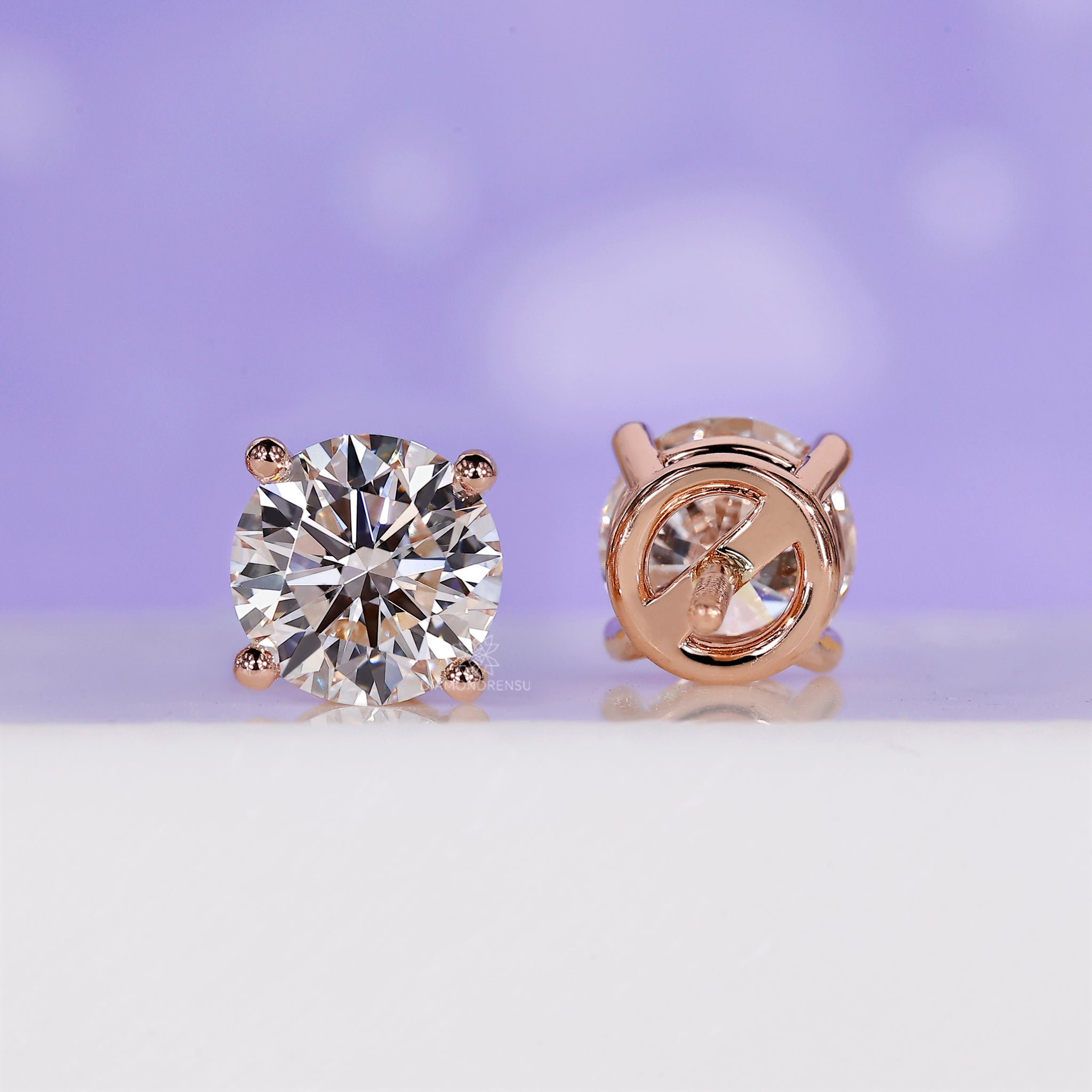 Screw back round diamond earrings.