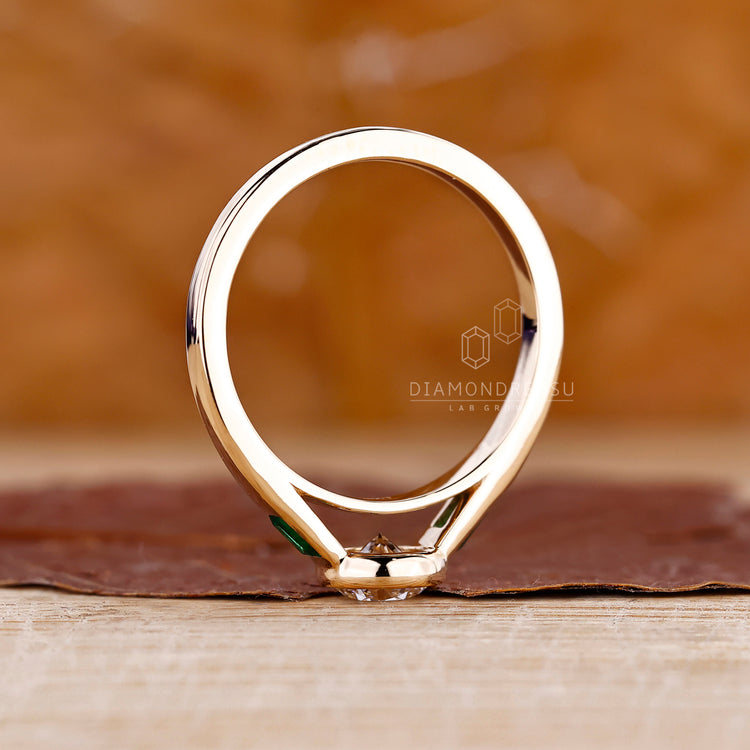 Emerald Tapered Baguette Cut placed beside round cut diamond.