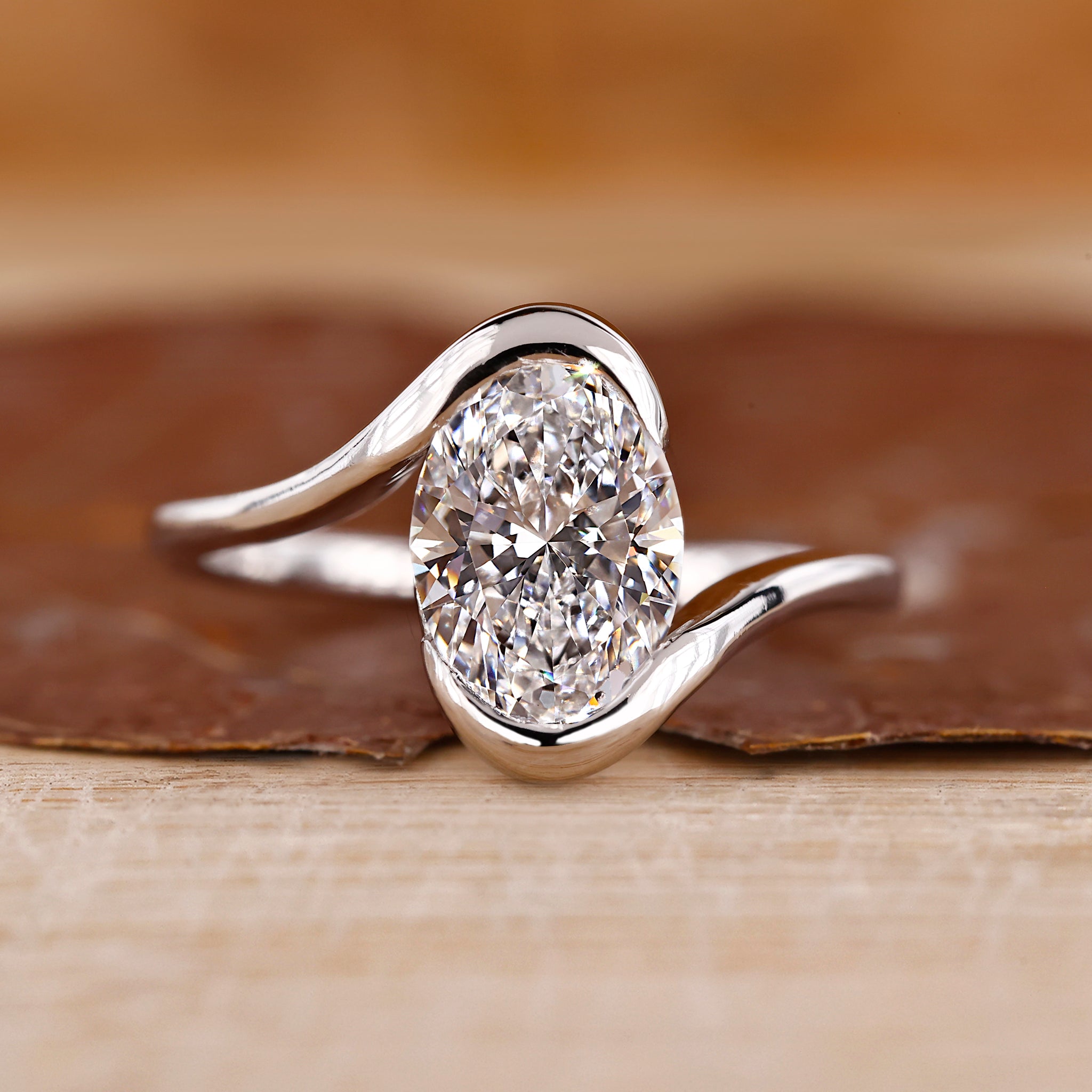 Solitaire engagement ring with oval diamond center.