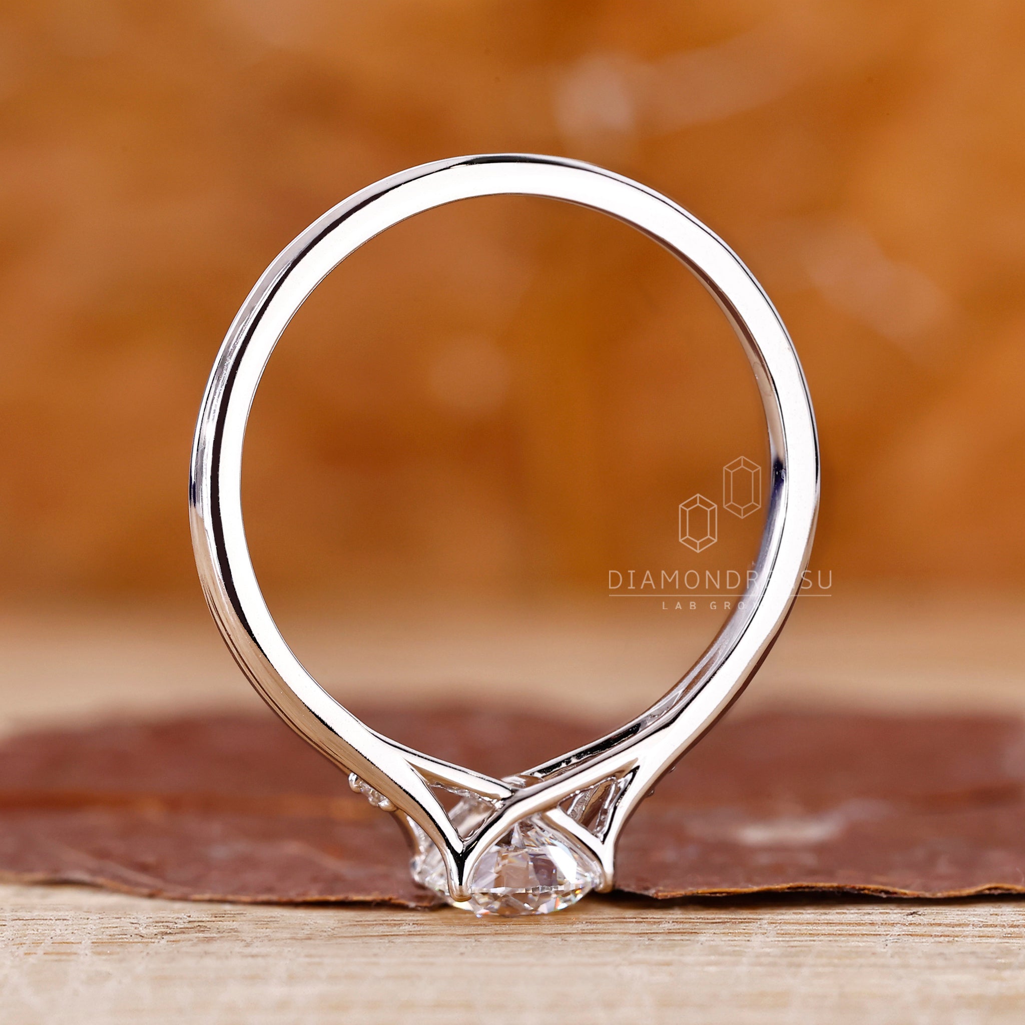 IGI certified diamond in 3 stone engagement ring.